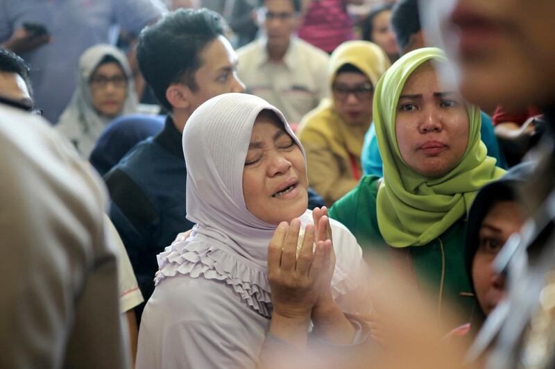 A relative of passengers prays as she and others wait for news on the Lion Air plane. AP Photo