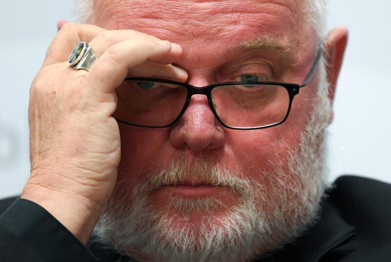 Cardinal Reinhard Marx, head of the german bishops' conference, ponders during a press conference on a report on sexual abuse of minors within the German Catholic Church in Fulda, central Germany, Tuesday, Sept. 25, 2018. (Arne Dedert/dpa via AP)