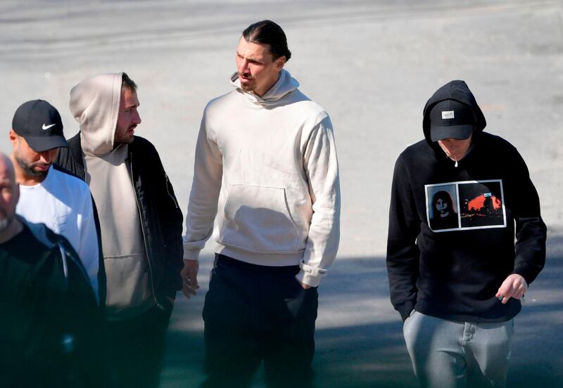 Zlatan Ibrahimovic talks with fans as he leaves the Arsta IP training ground in Stockholm after participating in a training session with the Swedish club Hammarby. AFP