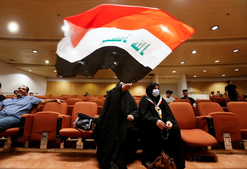 A woman holds an Iraqi flag as supporters of Iraqi populist leader Moqtada al-Sadr gather during a sit-in at the parliament building, amid political crisis in Baghdad, Iraq August 3, 2022.  REUTERS / Ahmed Saad