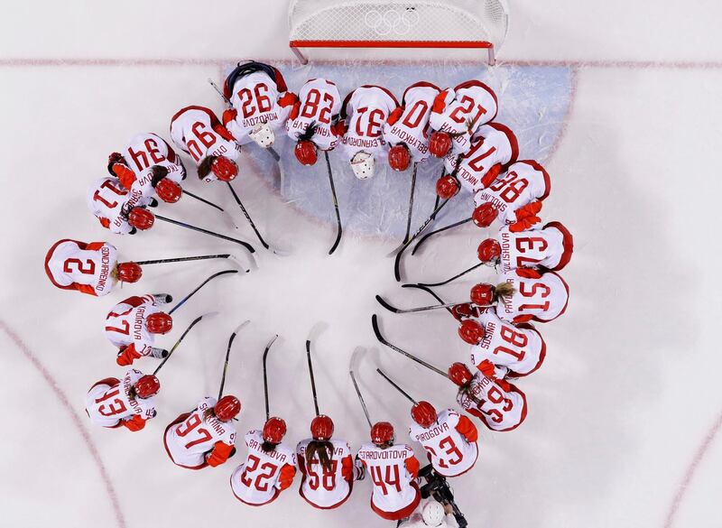 Russian athlete Nadezhda Morozova (92) huddles with teammates after the quarterfinal round of the women's hockey game against Switzerland at the 2018 Winter Olympics in Gangneung, South Korea. The team from Russia won 6-2. Frank Franklin II / AP Photo