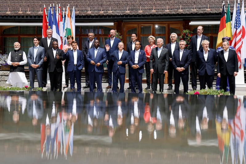 Olaf Scholz waves alongside G7 leaders and participants of the outreach programme as they pose for a 'family photo' at the Bavarian resort of Schloss Elmau. Reuters