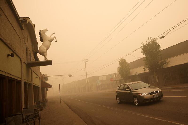 A car drives through the town of Molalla in Oregon, where about 10,000 residents were evacuated. Reuters