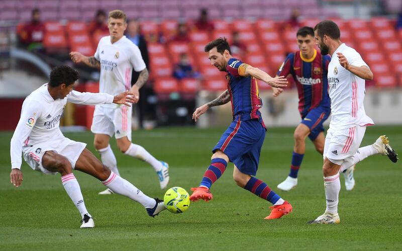 Barca's Lionel Messi surrounded by Real players. Getty