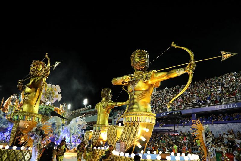 Members of Paraiso do Tuiuti samba school put on a show with golden floats. EPA