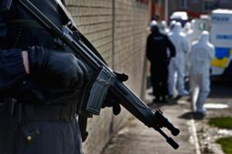 CRAIGAVON, UNITED KINGDOM - MARCH 12:  Police officers continue follow up searches at houses in Craigavon near to where gunmen shot Constable Stephen Carroll on March 12, 2009 in Craigavon, Northern Ireland. A large security presence is under way following the murders of two soldiers and a policeman by dissident republicans in the last week.  (Photo by Jeff J Mitchell/Getty Images) *** Local Caption ***  GYI0056959710.jpg