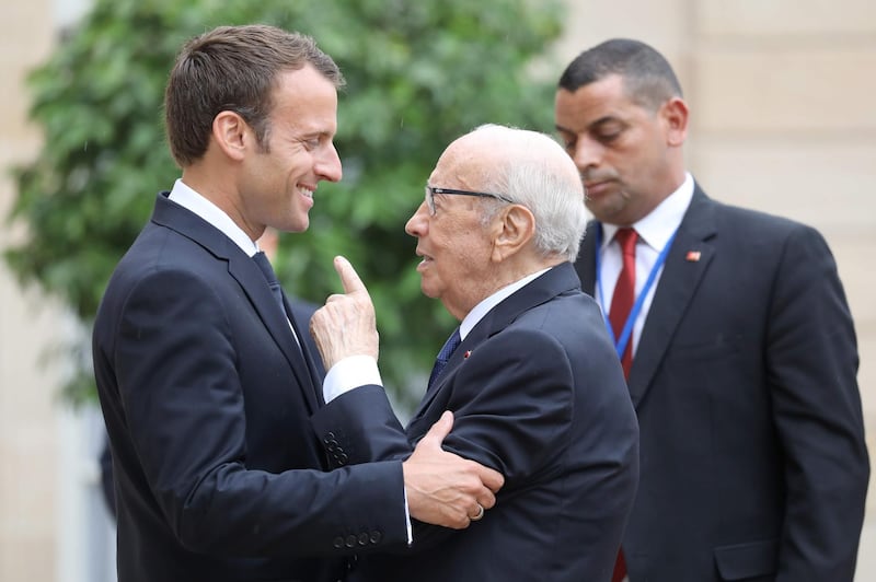 Essebi shares a joke with France's President Emmanuel Macron in May 2019  prior an international conference on Libya.  AFP