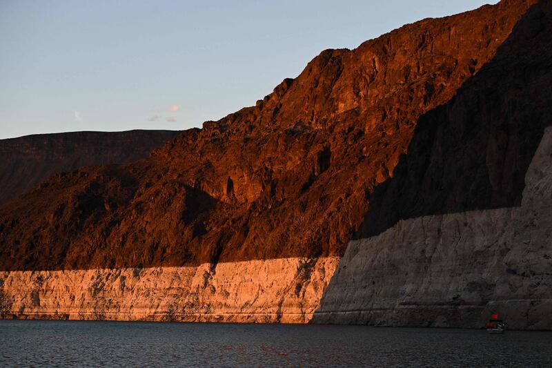 A 'bathtub ring', a white band of mineral deposits showing previous water levels, is illuminated at sunset at Lake Mead. AFP