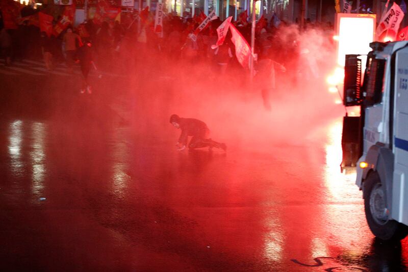 A fleeing protester falls after he was hit by a police water cannon during a rally against Turkey's Prime Minister Tayyip Erdogan in Ankara. Umit Bektas / Reuters