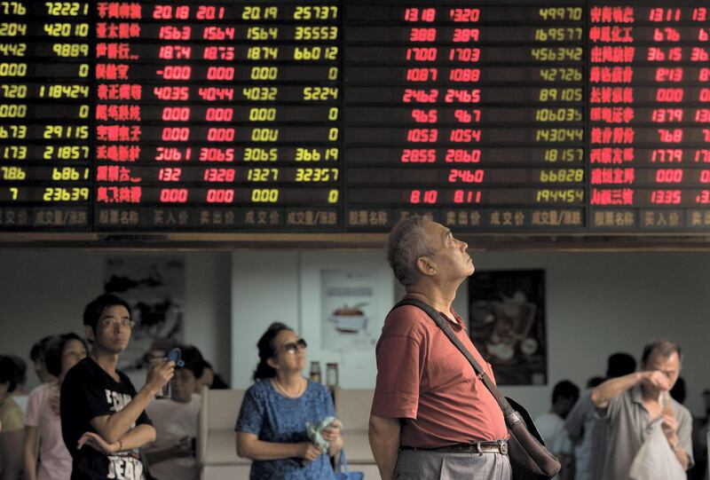 This photo taken on August 13, 2015 shows investors monitoring screens showing stock market movements at a brokerage house in Shanghai. Shanghai stocks were down 0.40 percent, or 15.01 points to 3,779.10, by the break on August 20, 2015, narrowing morning losses on expectations of more government support measures for equities following volatile trading the previous day, dealers said.       AFP PHOTO / JOHANNES EISELE (Photo by JOHANNES EISELE / AFP)
