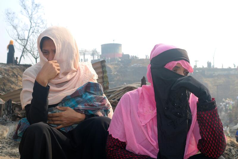 Rohingya refugees cry at the site of Monday's fire at a Rohingya refugee camp in Balukhali, southern Bangladesh. AP Photo