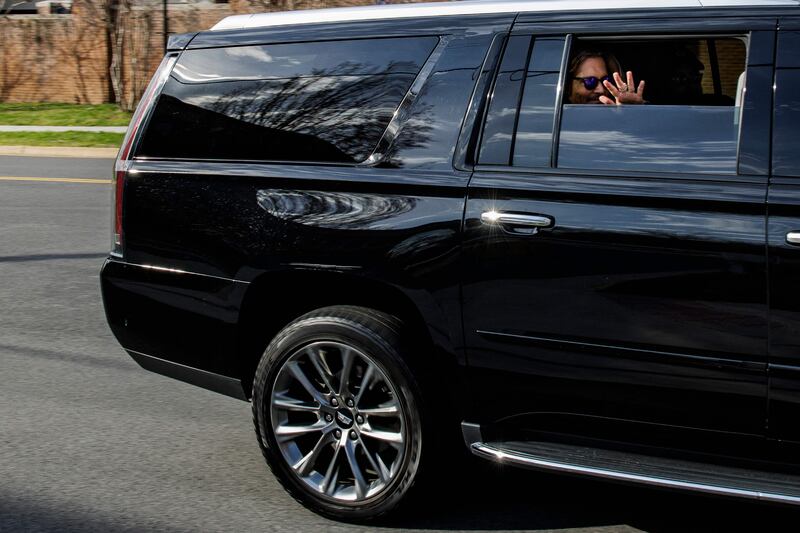 Johnny Depp waves to fans from the back of his vehicle. AFP