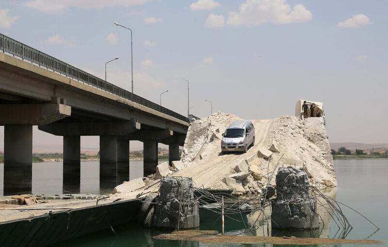 A bridge destroyed by ISIL as the US-backed alliance of Kurdish and Arab fighters advances into Manbij on June 23, 2016. Delil Souleiman / AFP