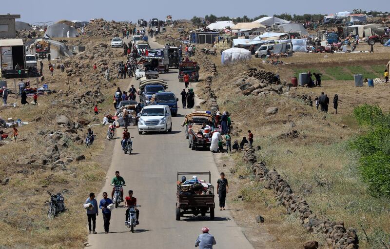 Internally displaced people from Deraa province arrive near the Israeli-occupied Golan Heights in Quneitra, Syria. Alaa Al-Faqir / Reuters