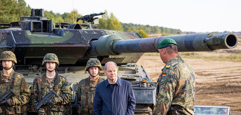 Chancellor Olaf Scholz talks to German soldiers next to a Leopard 2 main battle tank during an exercise in Ostenholz in October. AP