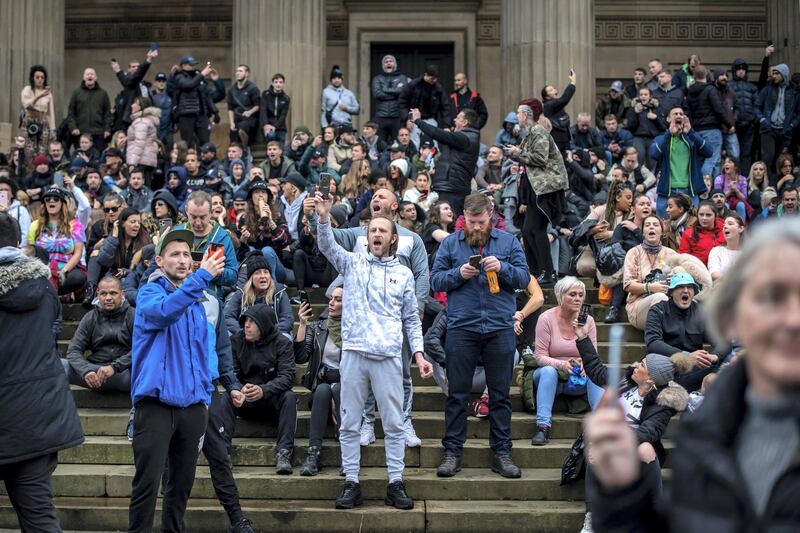 LIVERPOOL, ENGLAND - NOVEMBER 14: Crowds not wearing face masks gather at St George's Hall during an anti lockdown protest on November 14, 2020 in Liverpool, England. Throughout the Covid-19 pandemic, there have been recurring protests across England against lockdown restrictions and other rules meant to curb the spread of the virus. Police in Liverpool have warned protesters that they will take action against protesters, who could face possible fines.  (Photo by Anthony Devlin/Getty Images)