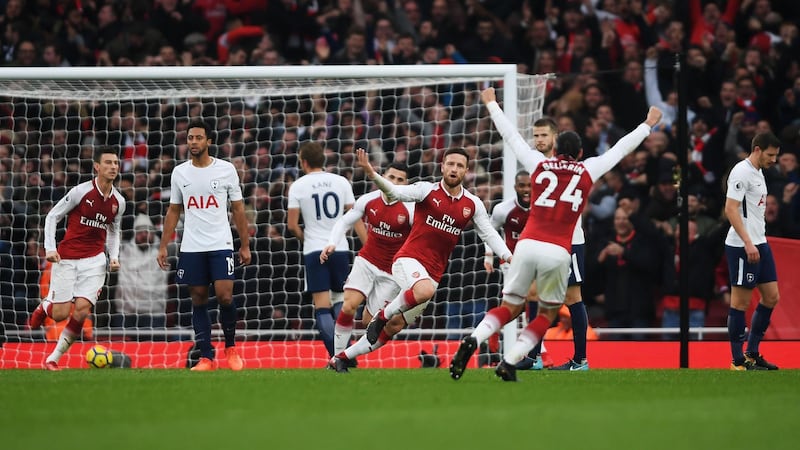 LONDON, ENGLAND - NOVEMBER 18:  Shkodran Mustafi of Arsenal celebrates with team mates after scoring his sides first goal during the Premier League match between Arsenal and Tottenham Hotspur at Emirates Stadium on November 18, 2017 in London, England.  (Photo by Mike Hewitt/Getty Images)