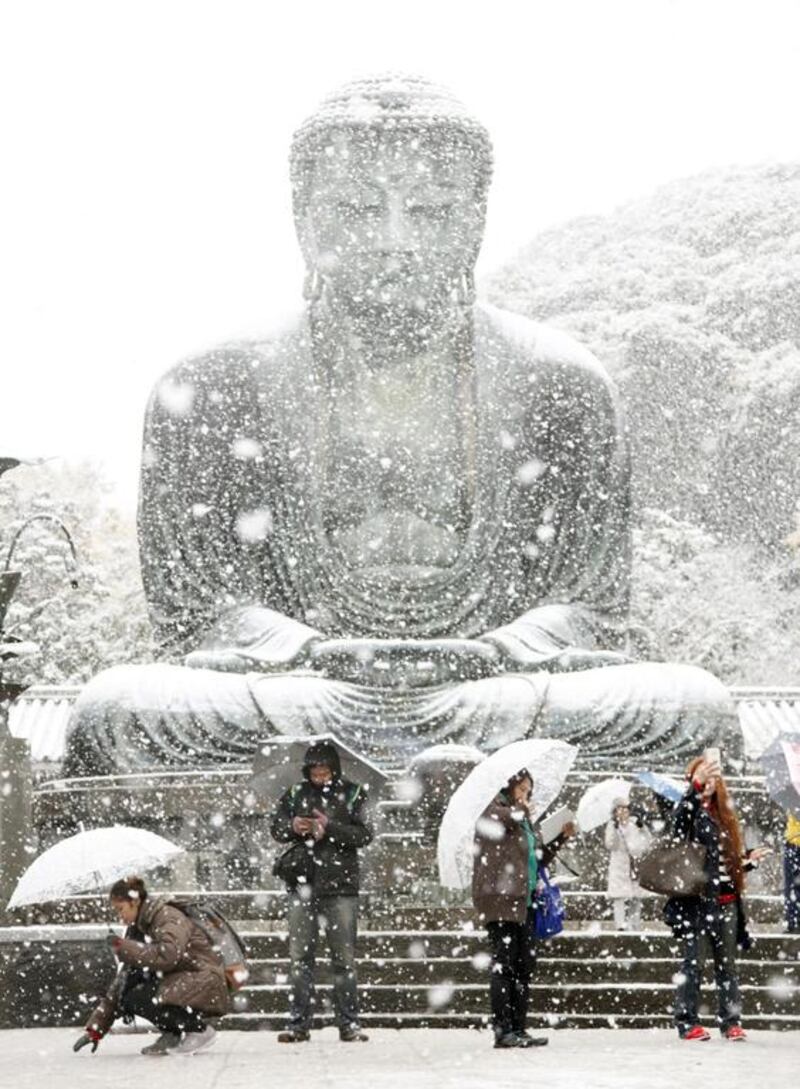 The Great Buddha statue is covered with snow at Kotoku-in temple in Kamakura, near Tokyo. Kazuhiro Ibuki / Kyodo News via AP
