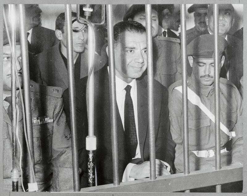 (Original Caption) Former Egyptian War Minister Shams Badran is flanked by military men during his trial before the Revolution Command Council on January 22nd. Badran and 53 other former Army officers and civilians have been accused of plotting a "bloody coup" to over throw the government of UAR President Gamal Abdel Nasser under the leadership of the late UAR Vice President, Field Marshal Abdul Hakim Amer.