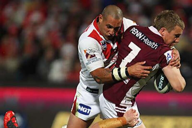 Manly's Trent Hodkinson is halted by the Dragons defence during their 32-10 defeat at WIN Jubilee Oval last night.
