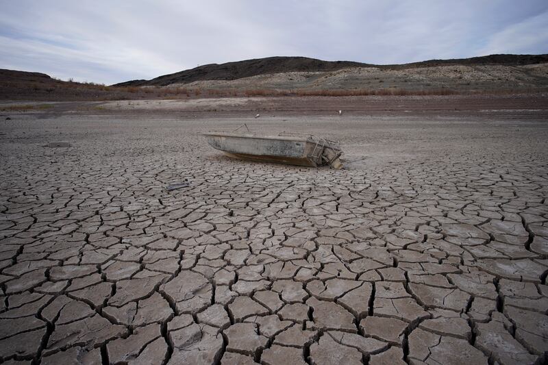 A sunken boat sits on cracked earth hundreds of metres from the shoreline of Lake Mead in Boulder City, Nevada, the US. AP