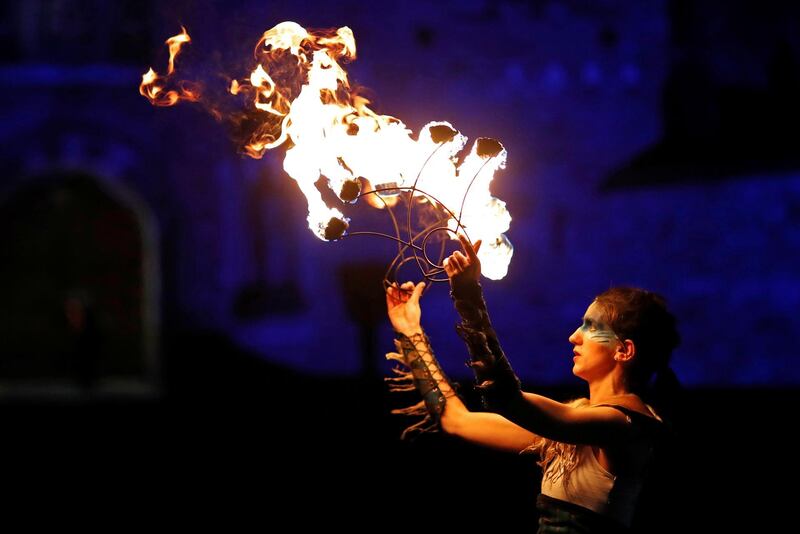 A member of PyroCeltica poses in front of Edinburgh Castle in advance of Edinburgh's Hogmanay Torchlight Procession down the Royal Mile in Edinburgh, Scotland, Britain, December 30, 2019. REUTERS/Russell Cheyne