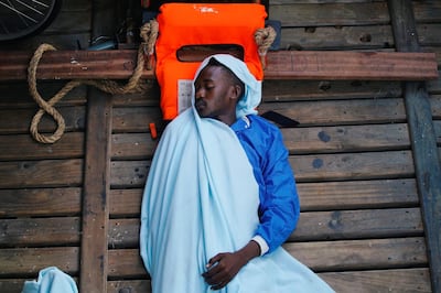 A migrant sleeps on board NGO Proactiva Open Arms rescue boat in central Mediterranean Sea, August 5, 2018. REUTERS/Juan Medina