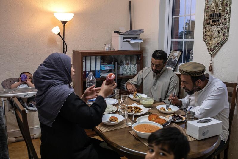 LONDON, ENGLAND - MAY 08: Imam Raza Ahmed, his brother Rizwan, wife Anam and two sons Daniel and Daud take iftar, the fast-breaking meal after sunset at their family home on May 08, 2020 in London, England. Ramadan is the ninth month of the Islamic calendar and the month in which the Quran was revealed to the prophet Muhammad. It is a time when Muslims around the world observe their faith with a month-long ritual of fasting and prayer, before making way for the holiday of Eid. With the coronavirus pandemic still at large and lockdowns still in place, close-knit religious communities have had to adapt to a new reality. Where once large gatherings at mosques every evening to break fast in the company of friends were commonplace, simpler home cooked meals in the company of immediate family are the new norm. The UK is continuing with quarantine measures intended to curb the spread of Covid-19, but as the infection rate is falling, government officials are discussing the terms under which it would ease the lockdown. (Photo by Dan Kitwood/Getty Images)