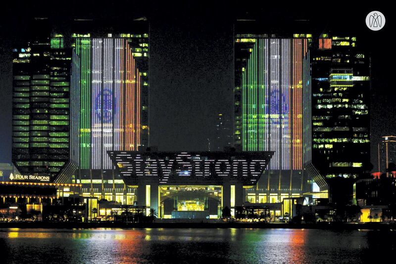 The Indian flag along with the message '#STAYSTRONGINDIA' is projected onto the exterior of the stock exchange in Abu Dhabi. Abu Dhabi Media Office