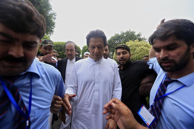 epa06933198 Imran Khan (C), head of Pakistan Tehrik-e-Insaf political party arrives to meet his party's workers in Peshawar, Pakistan, 07 August 2018. PTI parliamentary board nominated Imran Khan as the party's candidate for the Prime Minister. Former cricketer Imran Khan's Pakistan Tehreek-e-Insaf has emerged as the biggest party, securing 116 of the 272 seats in the National Assembly, according to the Election Commission of Pakistan.  EPA/ARSHAD ARBAB