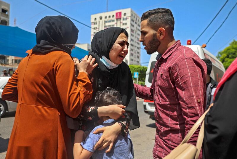A Palestinian woman is comforted after fleeing a building targeted by an Israeli bombardment in Gaza City. AFP