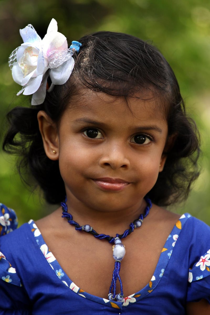 epa03638834 A Sri Lankan pre-schooler attired in her best and most colourful dress for the Sinhala and Tamil New Year celebrations in her school in Colombo, Sri Lanka, 24 March 2013. The national new year is celebrated in mid April by both major communities the Sinhalese and the Tamils in the island coinciding with the midyear harvests. Schools, especially the pre-schools island-wide celebrate a token event with most traditional customs being performed before they close their term for the New Year in April.  EPA/M.A.PUSHPA KUMARA *** Local Caption ***  03638834.jpg