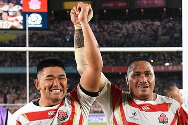 Japan's props Koo Ji-won (L) and Asaeli Ai Valu celebrate winning the Japan 2019 Rugby World Cup Pool A match between Japan and Scotland at the International Stadium Yokohama in Yokohama on October 13, 2019. / AFP / William WEST