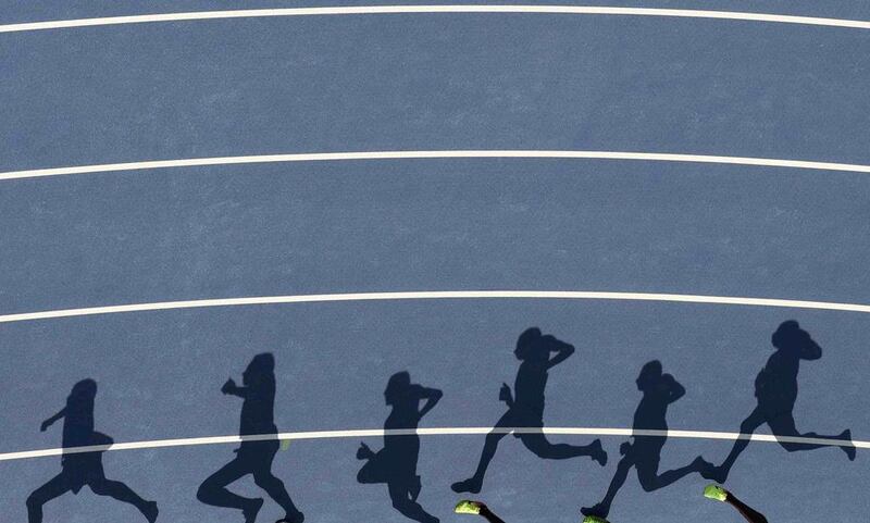 Shadows of a group of 5,000m runners appear on the track. Fabrizio Bensch / Reuters