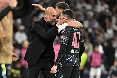 Manchester City's English midfielder #47 Phil Foden celebrates with Manchester City's Spanish manager Pep Guardiola and Manchester City's Portuguese defender #03 Ruben Dias scoring his team's second goal during the UEFA Champions League quarter final first leg football match between Real Madrid CF and Manchester City at the Santiago Bernabeu stadium in Madrid on April 9, 2024.  (Photo by JAVIER SORIANO  /  AFP)