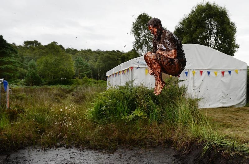 A male entrant takes a dip in the Bog Jacuzzi after competing in the Irish Bog Snorkelling championship on Sunday. Charles McQuillan / Getty Images 