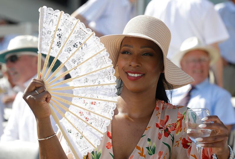 A spectator uses a fan to keep cool on the second day of the Test match between England and Ireland at Lord's cricket ground in London. AP