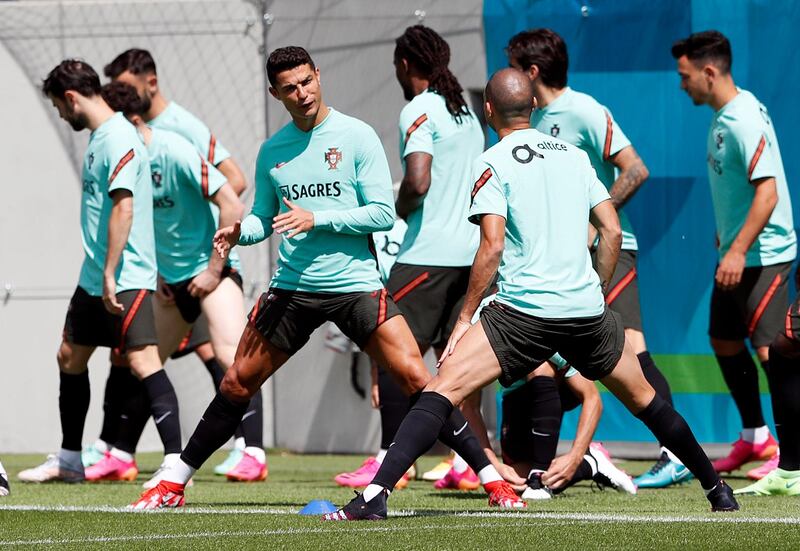 Cristiano Ronaldo and his Portugal teammates stretch during a training session at Illovszky Rudolf Stadium. Reuters