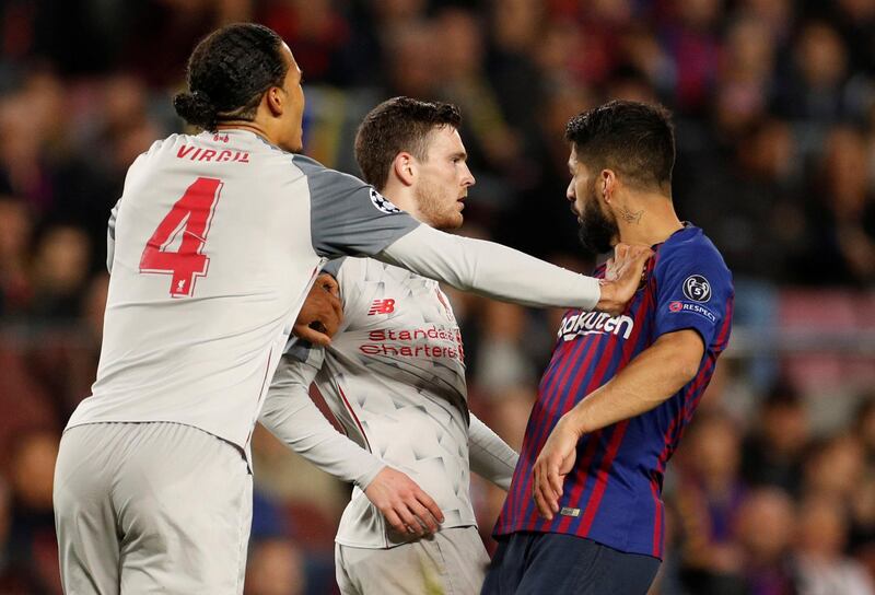 Liverpool's Virgil van Dijk and Andrew Robertson clash with Barcelona's Suarez. Action Images