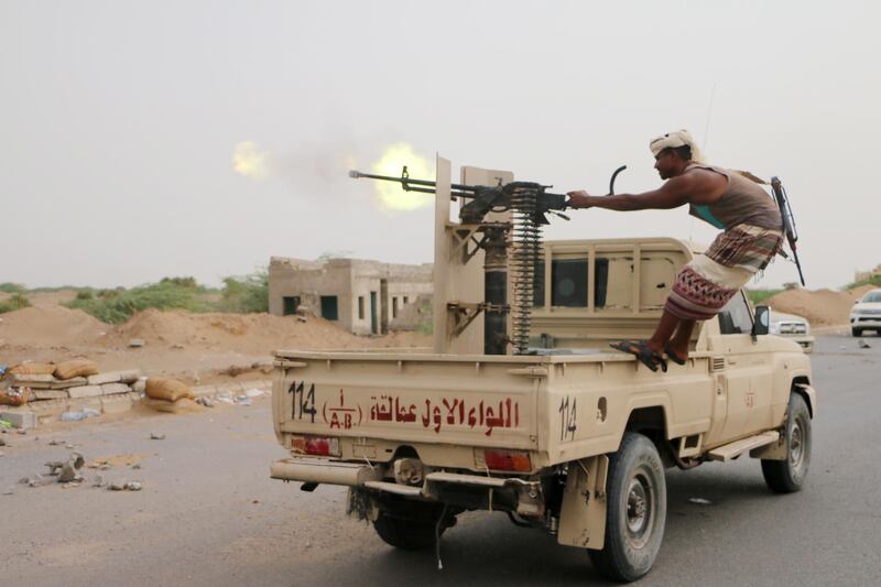 epa07708686 A member of Yemeni government forces fires a heavy machine gun during fighting against Houthi rebels on the outskirt of the port city of Hodeidah, Yemen, 10 July 2019. According to reports, a Yemeni demining unit has managed to clear more than 3500 landmines and explosives allegedly planted by the Houthi rebels in the port city of Hodeidah over the past six months.  EPA/NAJEEB ALMAHBOOBI