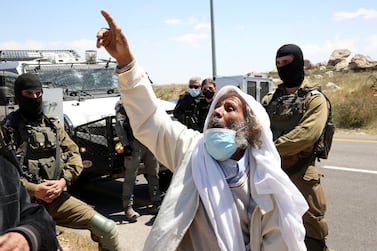 A Palestinian protester argues with Israeli security forces as he protests against Israeli settlement building activities on their land in the village of West Bank Yatta, near Hebron. EPA