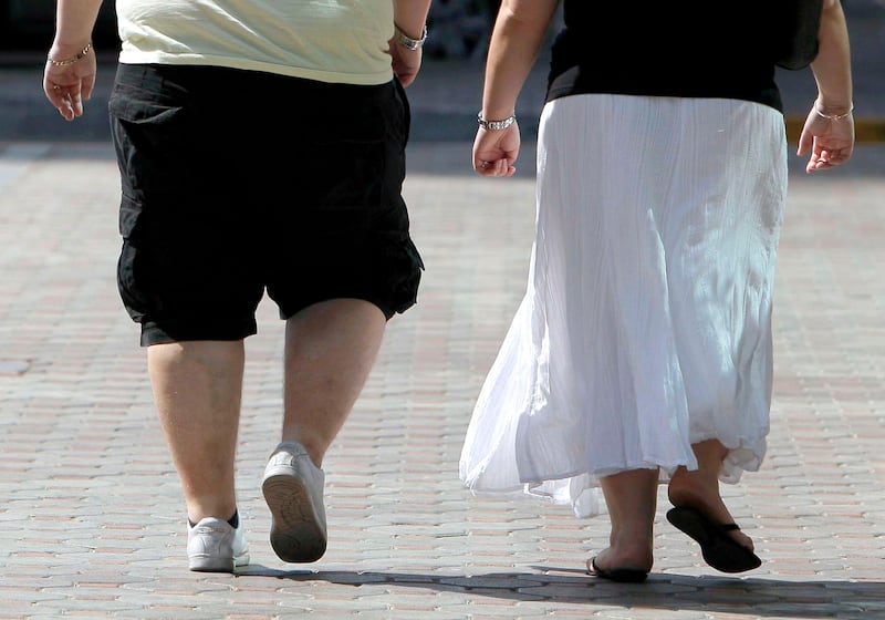ABU DHABI, UNITED ARAB EMIRATES - February 4, 2009: An obese couple walks down Zayed the First street in Abu Dhabi. ( Ryan Carter / The National )

obesity overweight obese fat