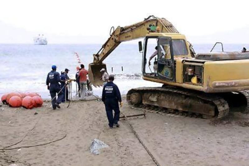 A fibre-optic cable being laid in Fujairah in 2009. Sabotage and cyber attacks have been identified as potential threats to UAE's telecom networks. Reuters
