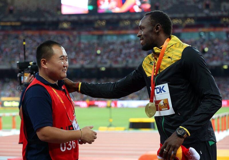 The TV cameraman who drove into Usain Bolt with a segway after the 200m final apologises to the Jamaican at the medal ceremony. How Hwee Young / EPA