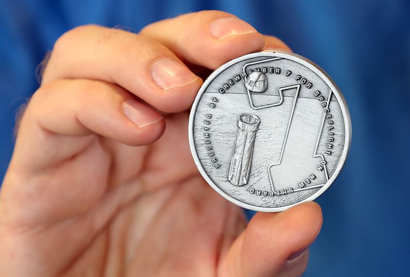 Mr Harding shows off a special coin that is awarded to Blue Origin passengers. Chris Whiteoak / The National