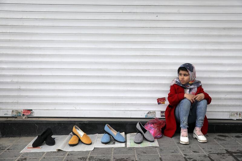 A vendor waits for customers ahead of the Persian New Year, or Nowruz, meaning "New Day." at Tajrish traditional bazaar in northern Tehran, Iran, Wednesday, March 17, 2021. (AP Photo/Ebrahim Noroozi)