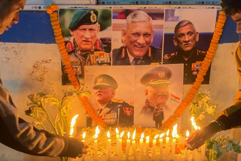 People light candles to pay their respect to defence chief Gen Bipin Rawat in Siliguri on December 8, 2021 after reports of a helicopter crash in which he and his wife were among 13 casualties. AFP