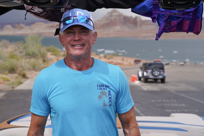 Cory Olsen, 64, poses on his motorboat at a boat ramp on Lake Powell. Mr Olsen has been boating on the lake since he was 12 and is alarmed by the low levels.