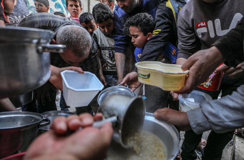 Palestinians gather to get soup offered for free during the Muslim holy month of Ramadan in Gaza City, Gaza Strip. Muslims around the world celebrate the holy month of Ramadan by praying during the night time and abstaining from eating, drinking, and sexual acts during the period between sunrise and sunset. Ramadan is the ninth month in the Islamic calendar, and it is believed that the revelation of the first verse in Koran was during its last 10 nights.  EPA