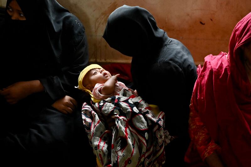 Women take shelter with their children on Shahpori island, Bangladesh. AFP